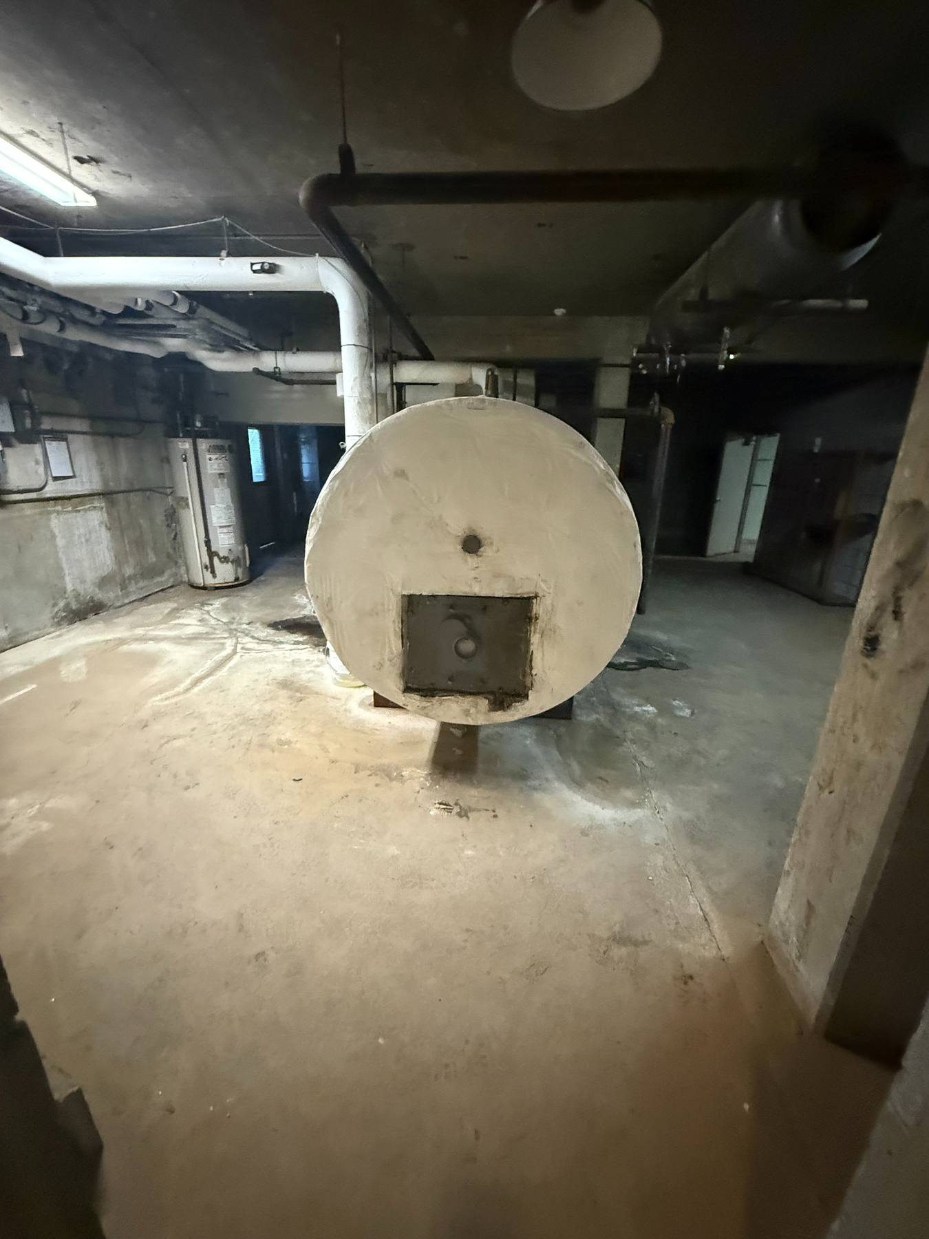 The building's original boiler in the basement, rusted and leaking.